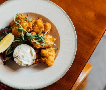 Savour delicious tempura fish with tartar sauce in our cosy hotel restaurant.